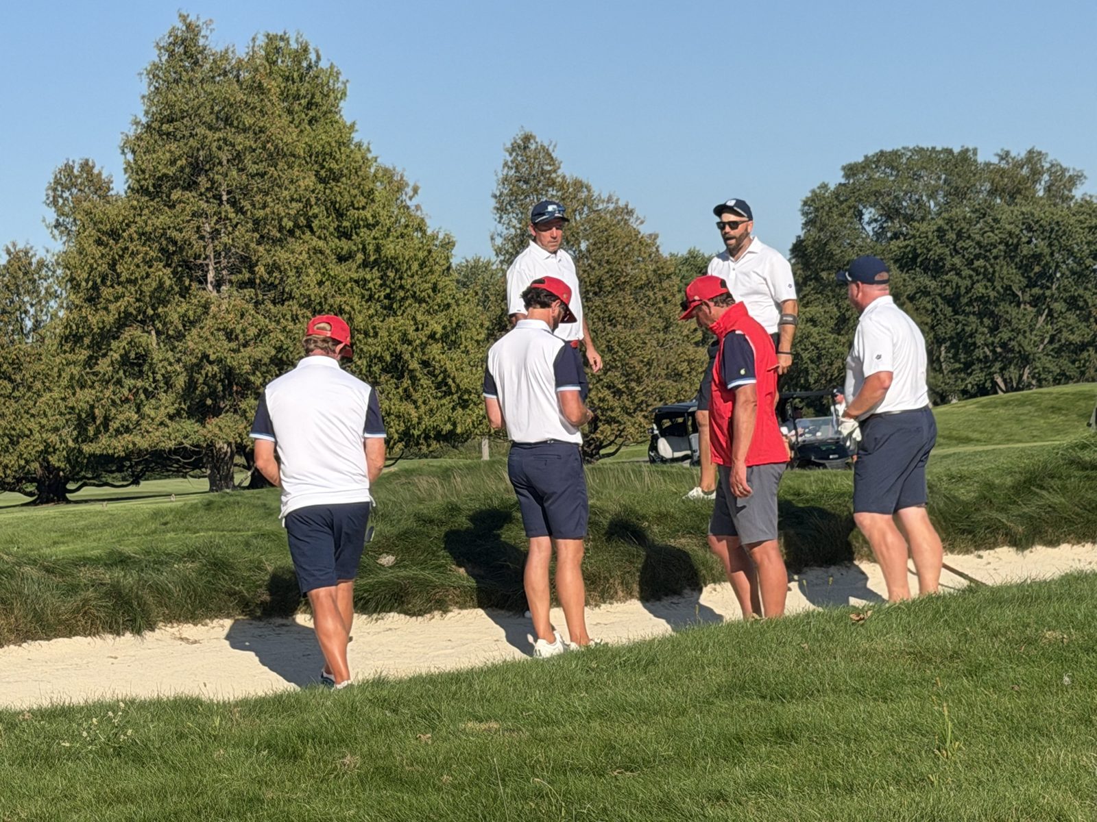 Two groups talking things over beside a bunker
