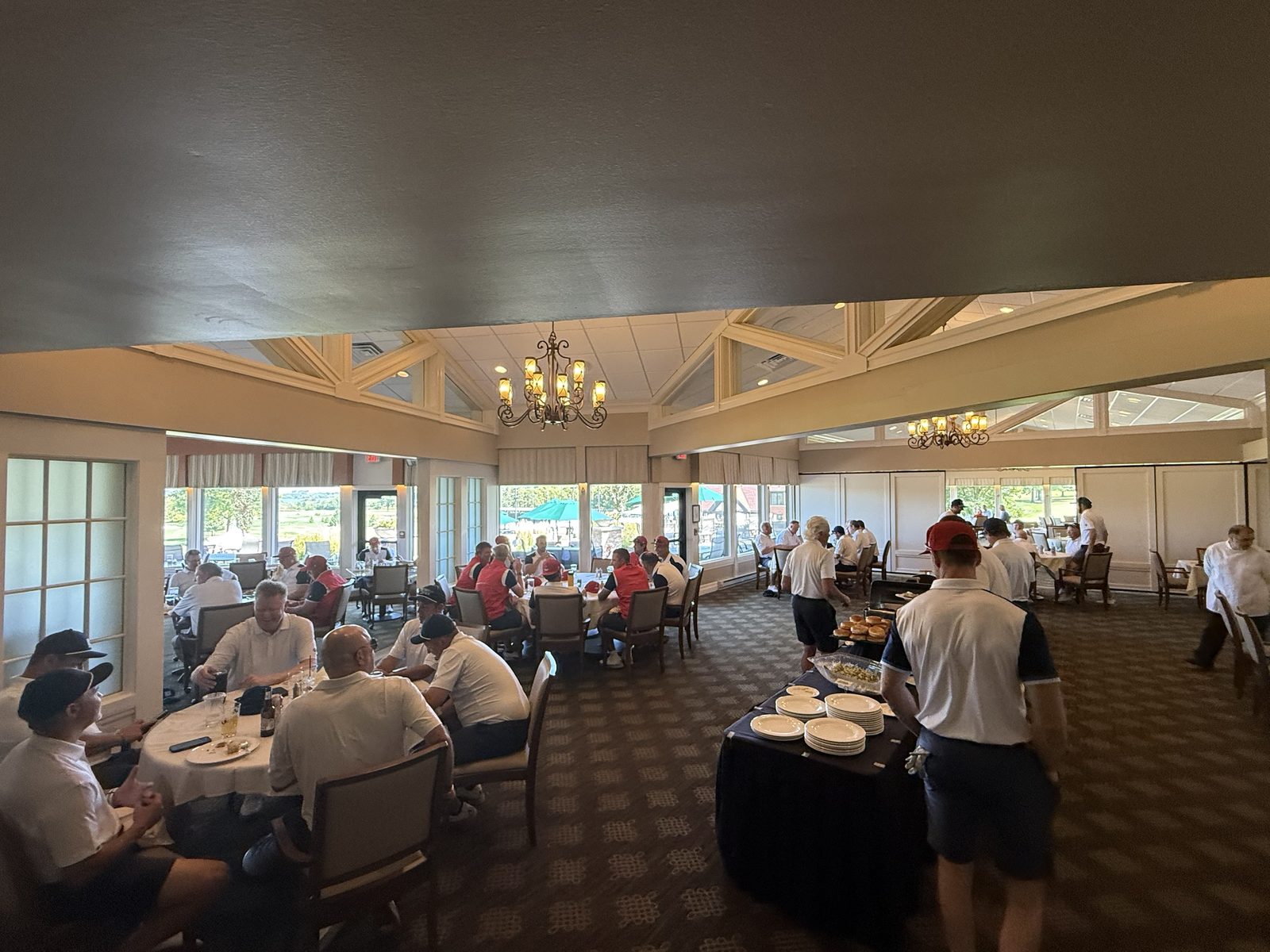 Both teams eating lunch in the Nakoma clubhouse