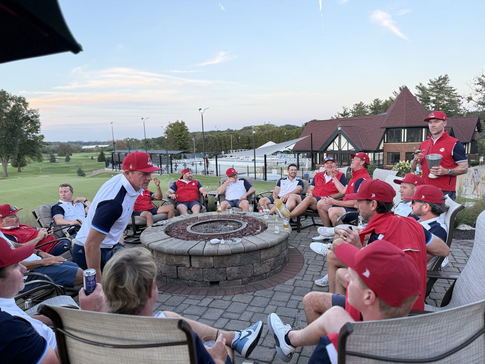 Players gathered around the fire pit at dusk