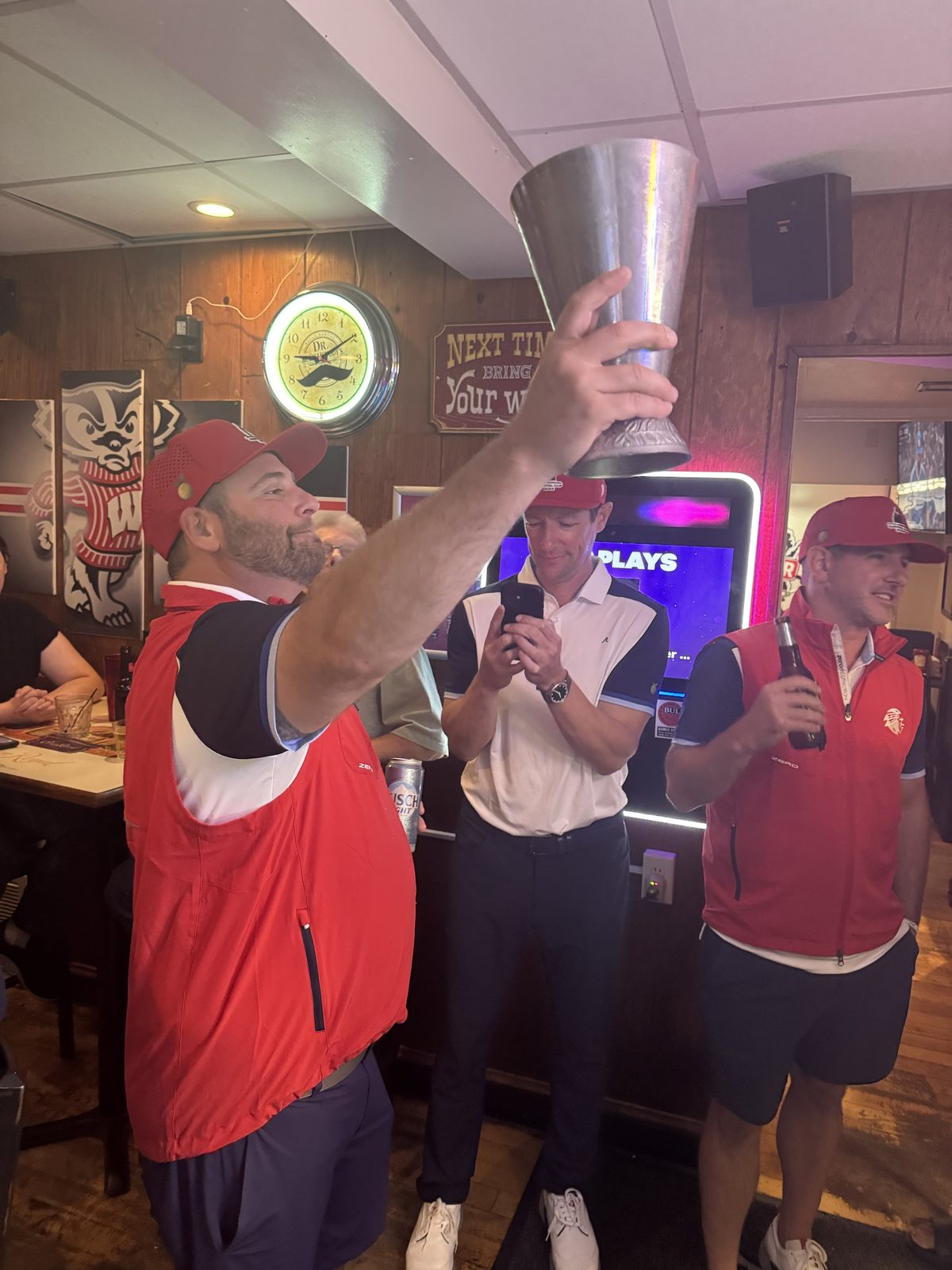 Player lifting the Capitol Cup trophy overhead